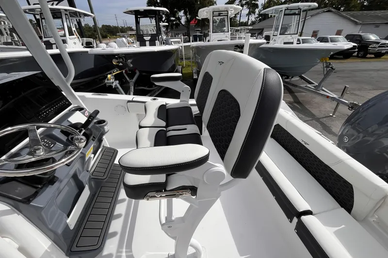 Slide: The Image of 2026 Tidewater 220 LXF boat interior with sleek seating and modern steering console. - 7