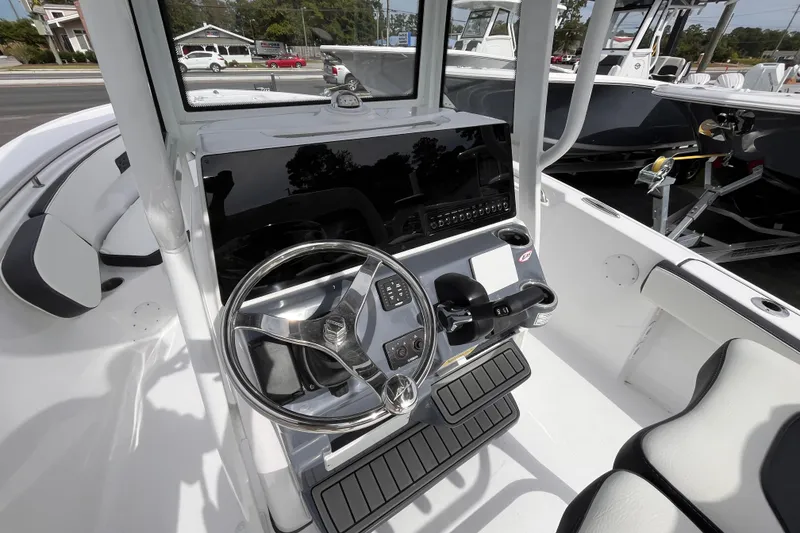 Slide: The Image of 2026 Tidewater 220 LXF boat cockpit with steering wheel and controls. - 8
