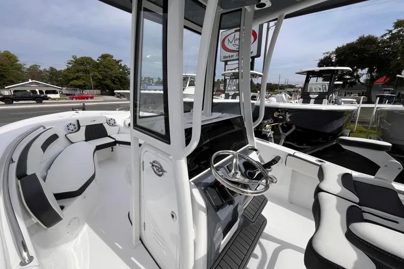 Slide: The Image of 2026 Tidewater 220 LXF boat interior with modern seating and steering console. - 9