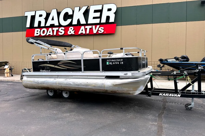 Slide: The Image of 2013 Northwood Oasis 1623 pontoon boat on Karavan trailer at Tracker Boats dealership. - 0