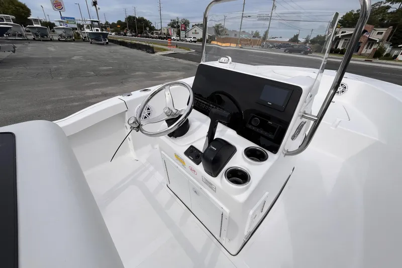 Slide: The Image of 2026 Tidewater 180 CC Adventure boat console with steering wheel and controls. - 7