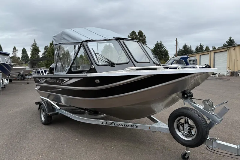 The Image of 2026 Thunder Jet 185 Luxor boat on trailer, parked outdoors under cloudy sky. - 0