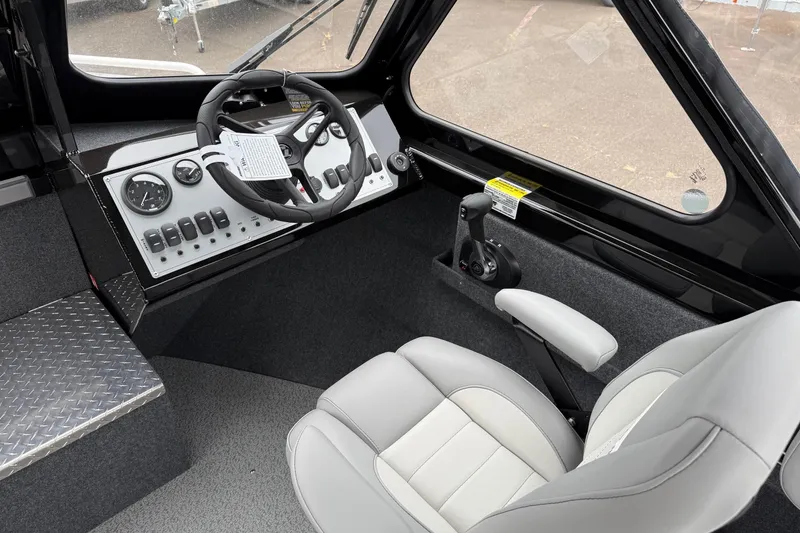Slide: The Image of 2026 Thunder Jet 185 Luxor boat interior with steering wheel and control panel. - 12