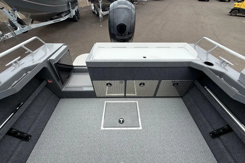 Slide: The Image of 2026 Thunder Jet 185 Luxor boat interior with storage compartments and motor. - 18