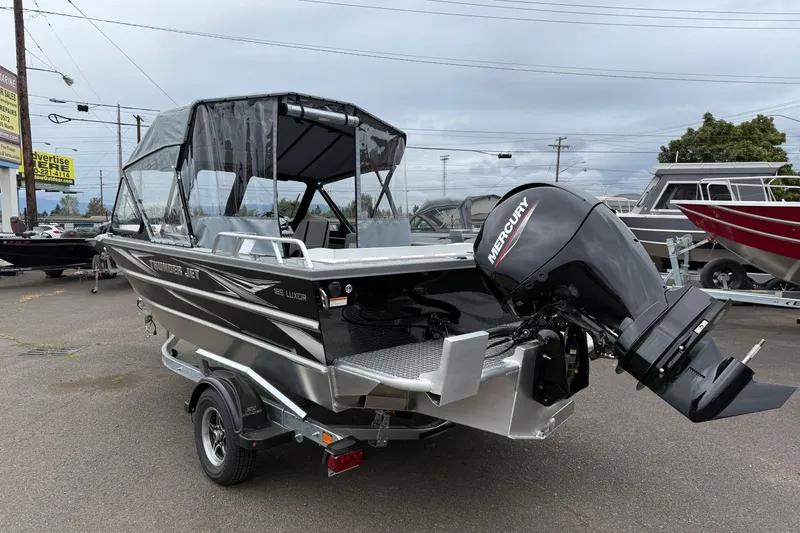 Slide: The Image of 2026 Thunder Jet 185 Luxor boat with Mercury outboard motor, parked outdoors. - 3