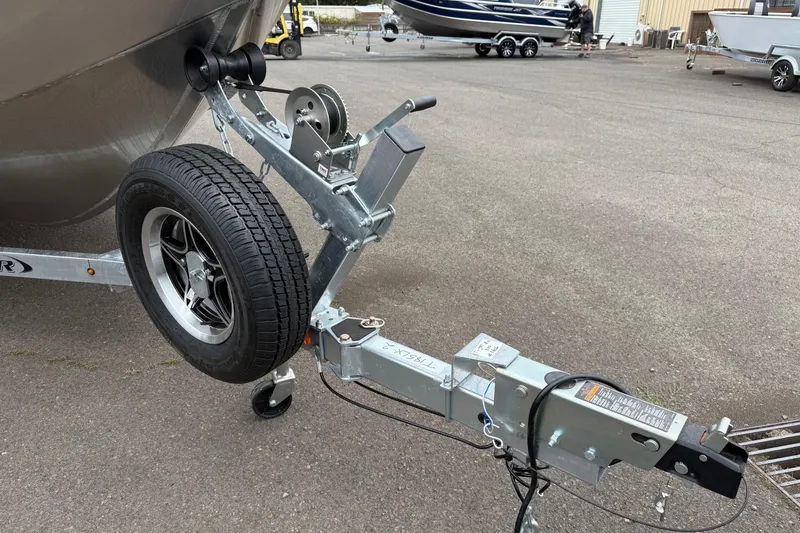 Slide: The Image of Trailer hitch and wheel of 2026 Thunder Jet 185 Luxor boat on pavement. - 31