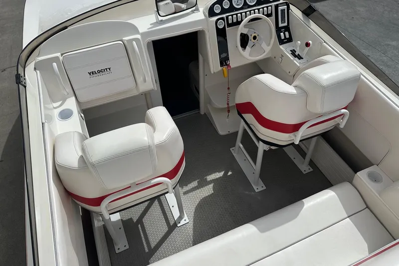Slide: The Image of 1998 Velocity 26 Thoroughbred boat interior with white and red seating, modern dashboard. - 11