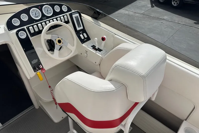 Slide: The Image of 1998 Velocity 26 Thoroughbred boat cockpit with white seats and control panel. - 13