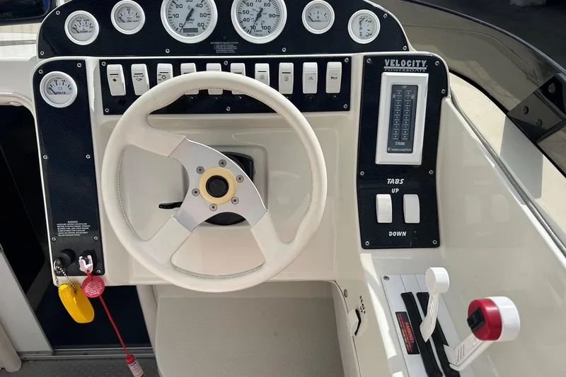 Slide: The Image of 1998 Velocity 26 Thoroughbred boat dashboard with steering wheel and control panel. - 15
