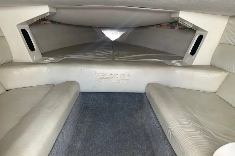 Slide: The Image of Interior cabin of a 1998 Velocity 26 Thoroughbred powerboat, featuring plush seating. - 19