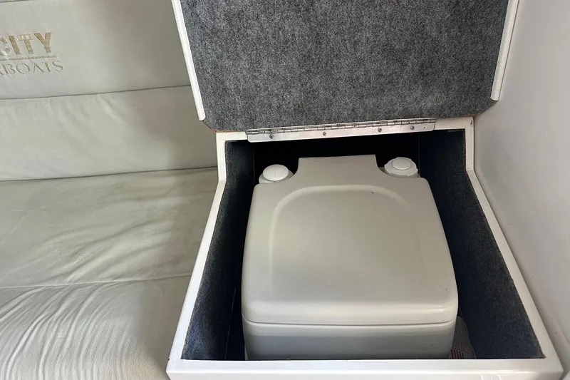 Slide: The Image of Portable toilet in a 1998 Velocity 26 Thoroughbred speedboat compartment. - 20