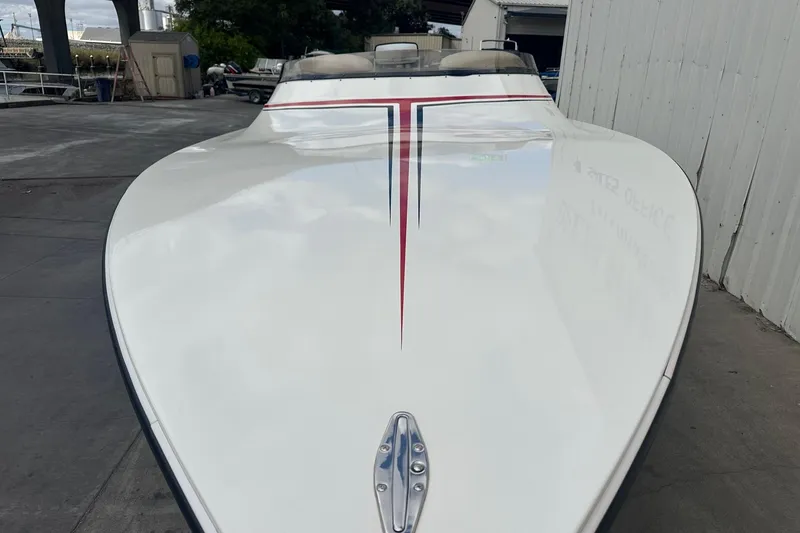 Slide: The Image of 1998 Velocity 26 Thoroughbred boat with sleek white hull and red stripe design. - 4