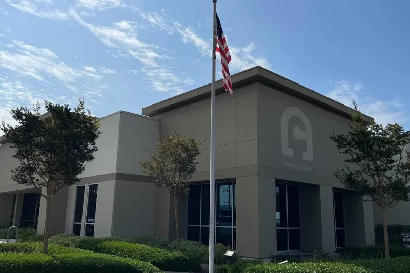 The Image of Modern building with American flag, trees, and clear sky; Rendova 11, 2001 model. - 1