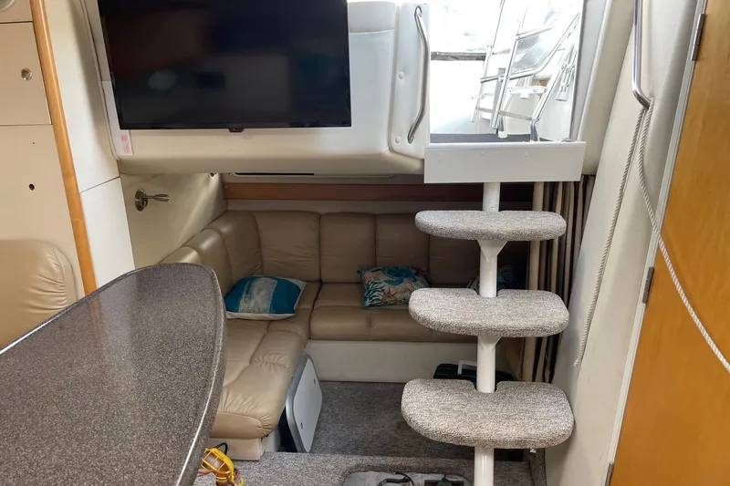 Slide: The Image of Interior of 2001 Larson Cabrio 330 boat with cozy seating and modern amenities. - 7