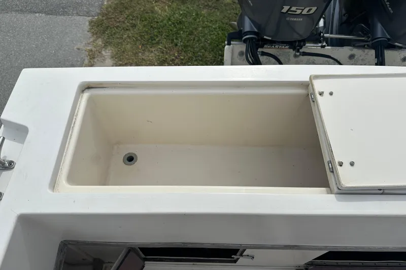 Slide: The Image of Open storage compartment on 1987 Grady-White Gulfstream 232 boat, with Yamaha engines visible. - 14