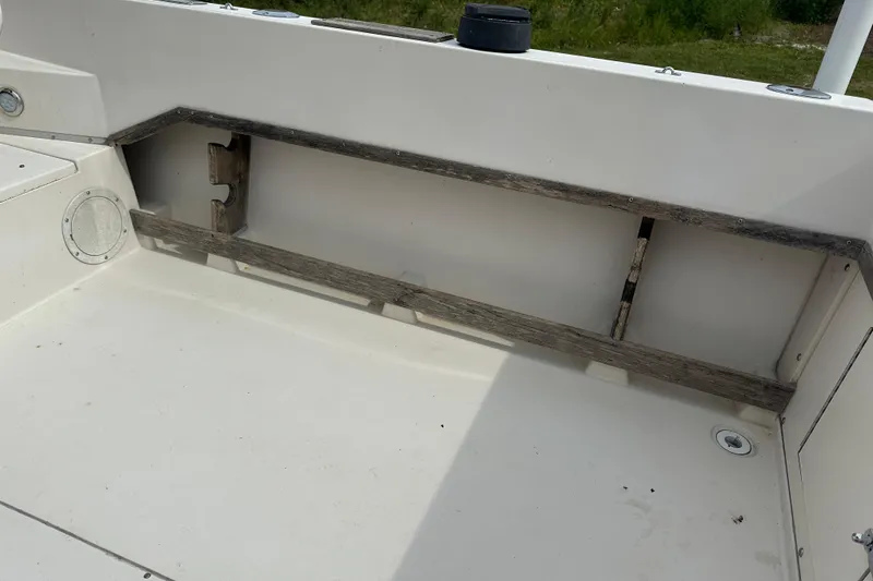 Slide: The Image of 1987 Grady-White Gulfstream 232 boat interior with wooden storage rack. - 20