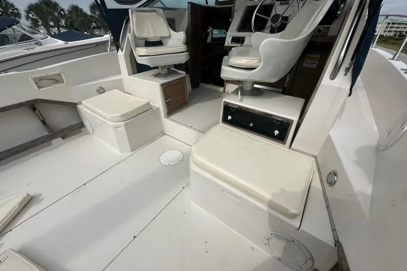 Slide: The Image of 1987 Grady-White Gulfstream 232 boat interior with white seating and steering area. - 24
