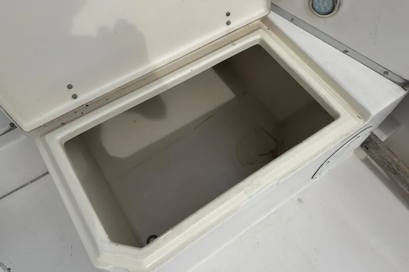 Slide: The Image of Open storage compartment on 1987 Grady-White Gulfstream 232 boat deck. - 27