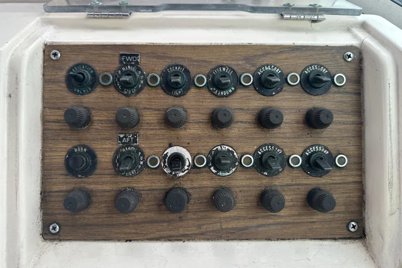 Slide: The Image of Control panel of a 1987 Grady-White Gulfstream 232 boat with switches and knobs. - 30