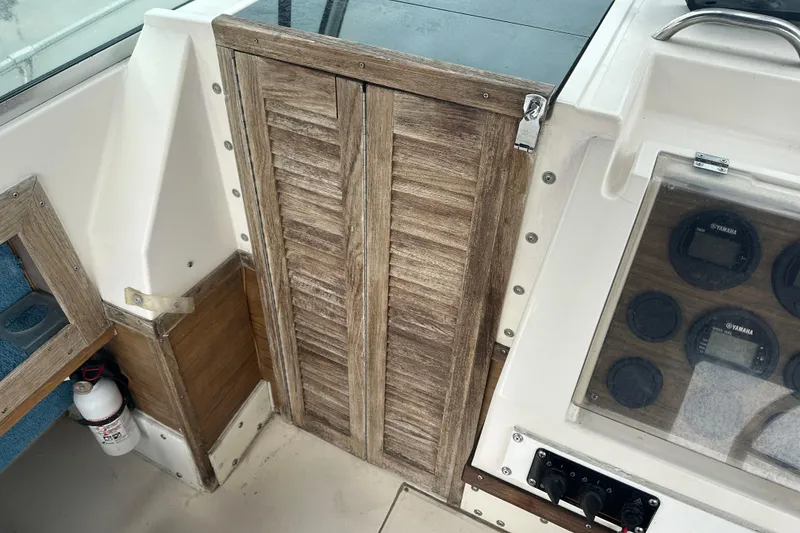 Slide: The Image of 1987 Grady-White Gulfstream 232 boat interior with wooden paneling and instrument gauges. - 37