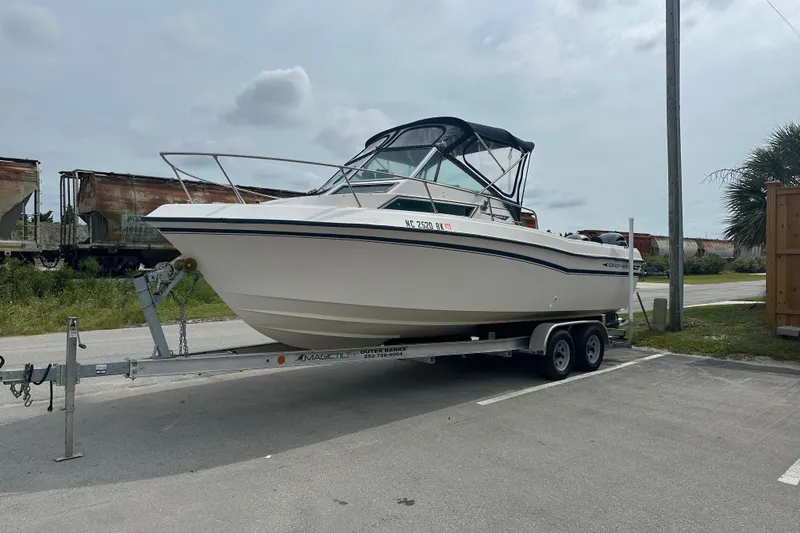 Slide: The Image of 1987 Grady-White Gulfstream 232 boat on trailer, parked outdoors. - 4