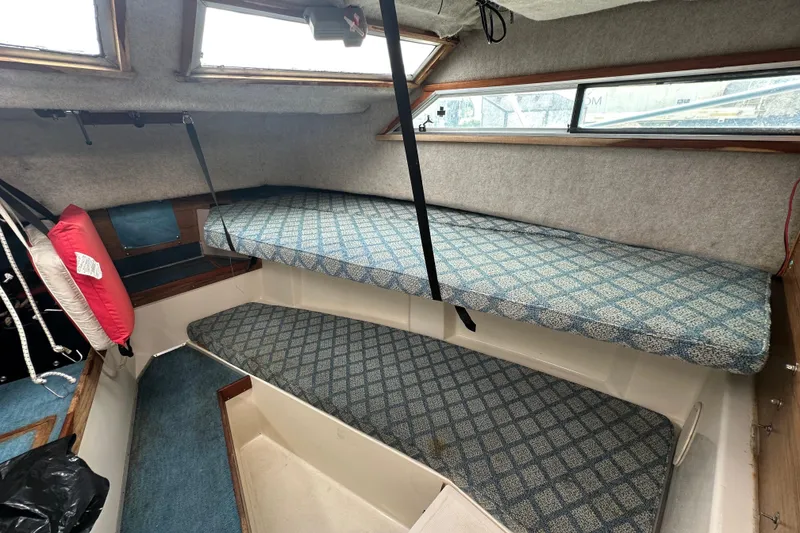 Slide: The Image of Interior cabin of 1987 Grady-White Gulfstream 232 boat with blue patterned cushions. - 40