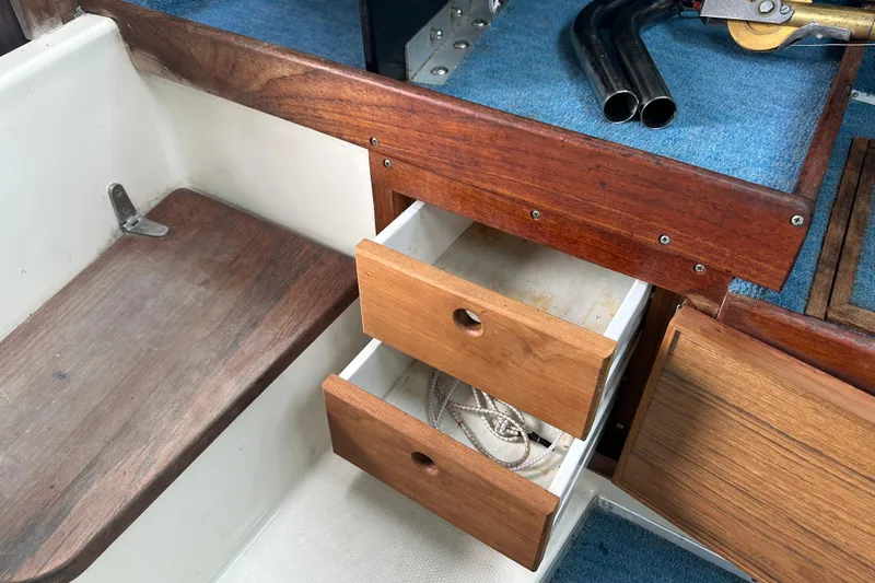 Slide: The Image of Wooden storage drawers on a 1987 Grady-White Gulfstream 232 boat interior. - 42