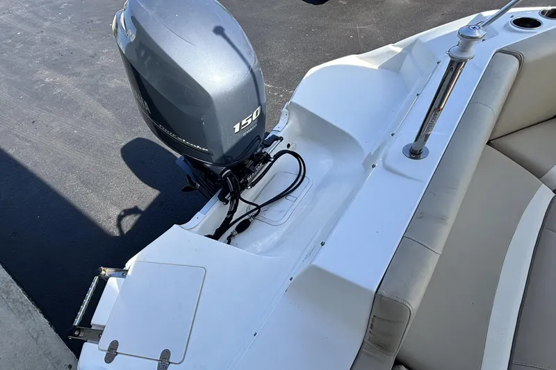 Slide: The Image of 2015 NauticStar 223 DC boat with Yamaha 150 outboard motor, rear seating view. - 10