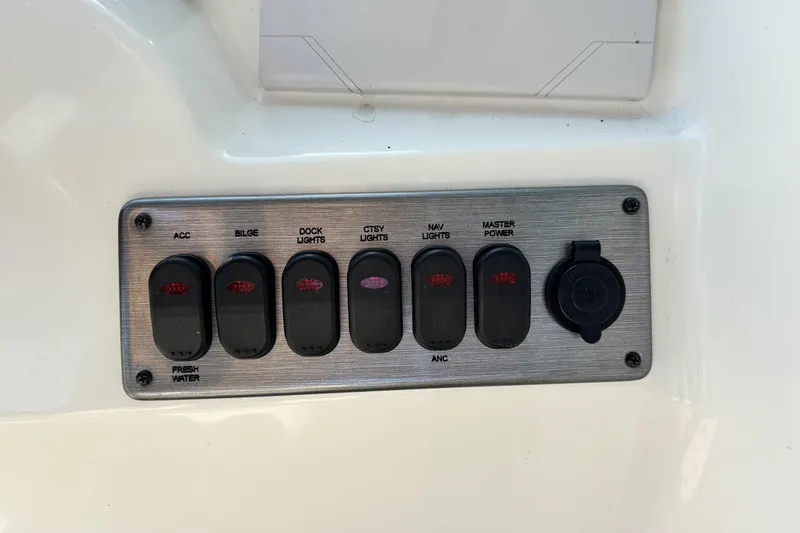 Slide: The Image of Control panel of a 2015 NauticStar 223 DC boat with labeled switches. - 18