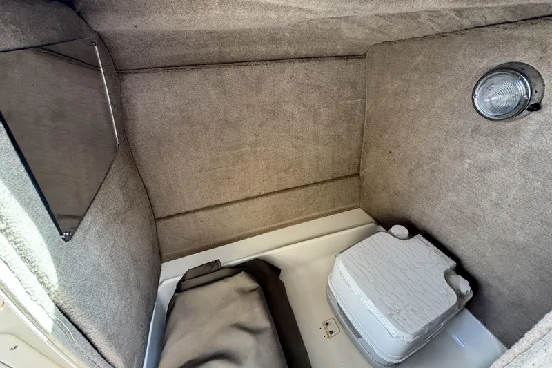 Slide: The Image of Interior cabin of 2015 NauticStar 223 DC boat with portable toilet and light. - 23