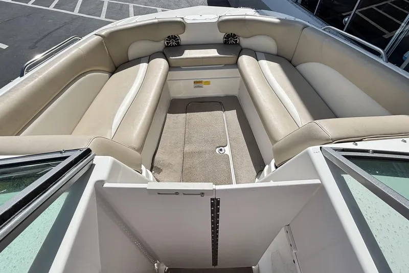 Slide: The Image of Interior view of a 2015 NauticStar 223 DC boat with beige seating. - 24