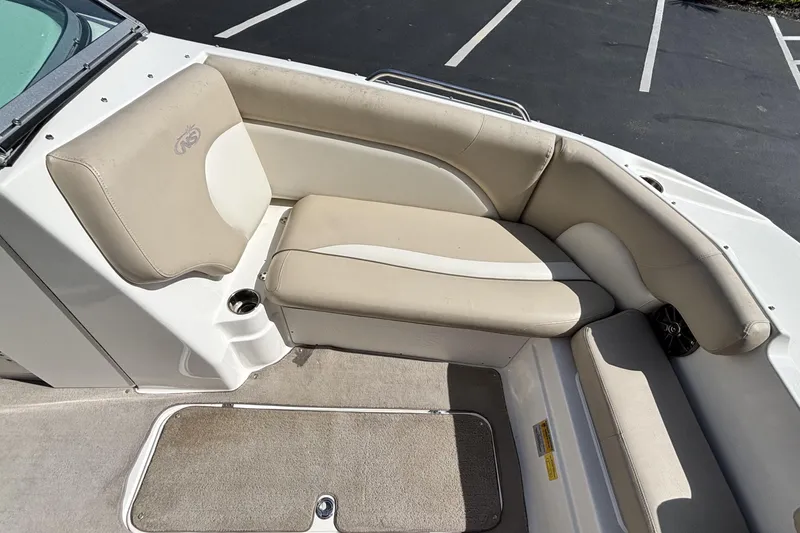 Slide: The Image of 2015 NauticStar 223 DC boat interior with beige seating and cup holder. - 27