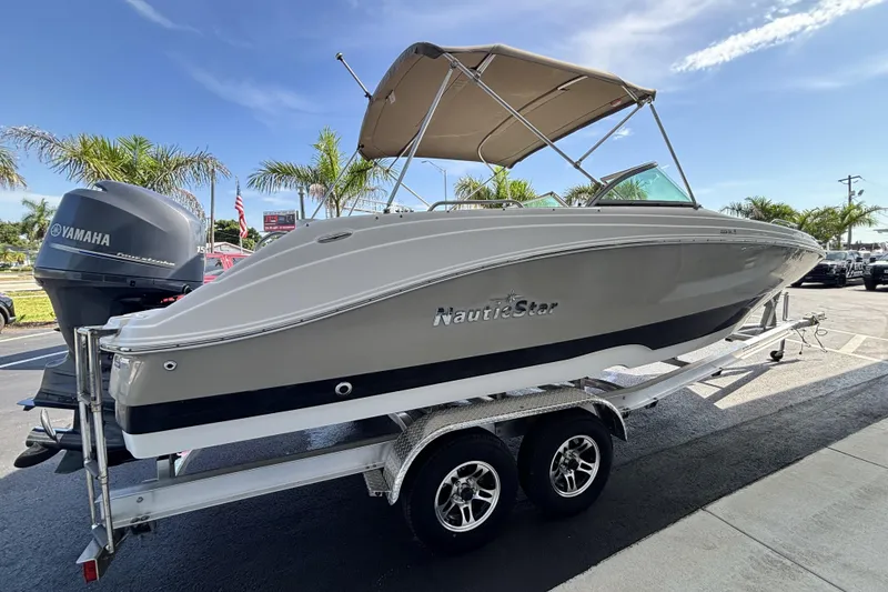 Slide: The Image of 2015 NauticStar 223 DC boat on trailer with Yamaha engine, parked outdoors. - 4