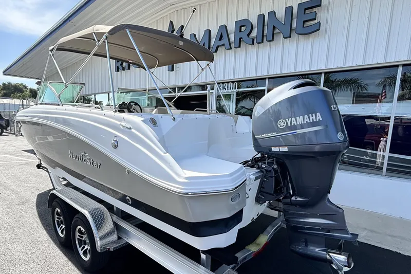 Slide: The Image of 2015 NauticStar 223 DC boat with Yamaha engine on trailer outside marine dealership. - 6