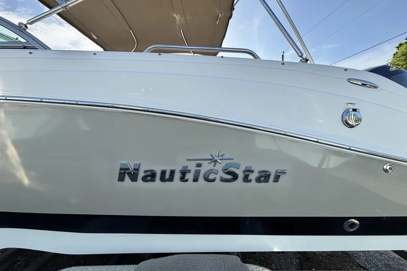 Slide: The Image of 2015 NauticStar 223 DC boat with sleek white exterior and logo. - 8