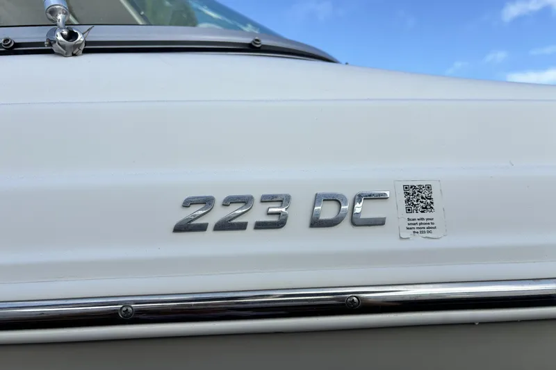 Slide: The Image of 2015 NauticStar 223 DC boat emblem with QR code on white surface. - 9