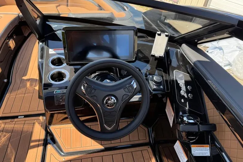 Slide: The Image of 2026 Yamaha Boats 275SD dashboard with steering wheel, touchscreen, and cup holders. - 11