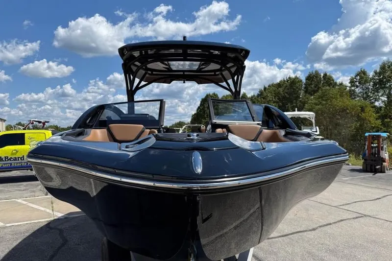Slide: The Image of 2026 Yamaha Boats 275SD, sleek design, parked outdoors under a blue sky. - 2