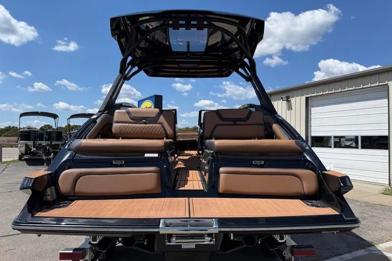 Slide: The Image of 2026 Yamaha Boats 275SD with luxurious seating and sleek design under a clear sky. - 5