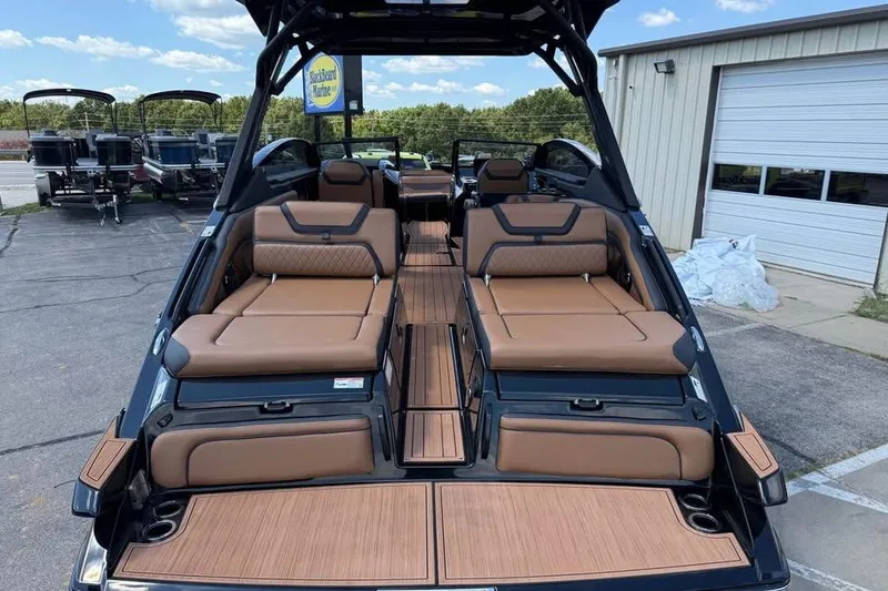 Slide: The Image of 2026 Yamaha Boats 275SD with luxurious seating and sleek design at a marina. - 6