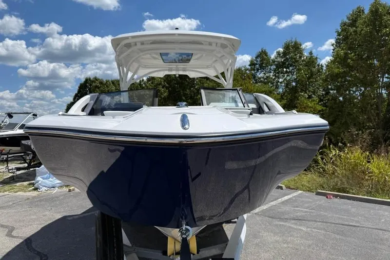 Slide: The Image of 2026 Yamaha Boats 275SD, sleek design, parked outdoors under a blue sky. - 2