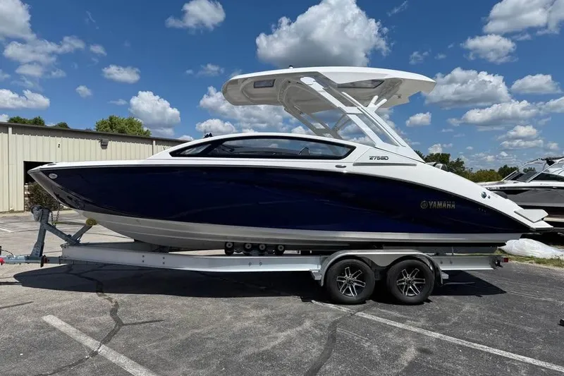 Slide: The Image of 2026 Yamaha Boats 275SD on trailer under blue sky with clouds. - 4