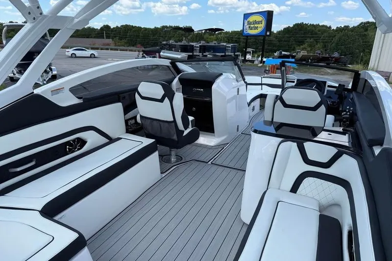 Slide: The Image of 2026 Yamaha Boats 275SD interior with modern seating and sleek design at BlackBeard Marine. - 8