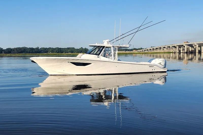 The Image of 2023 Pursuit S 378 Sport boat on calm water near a bridge. - 0