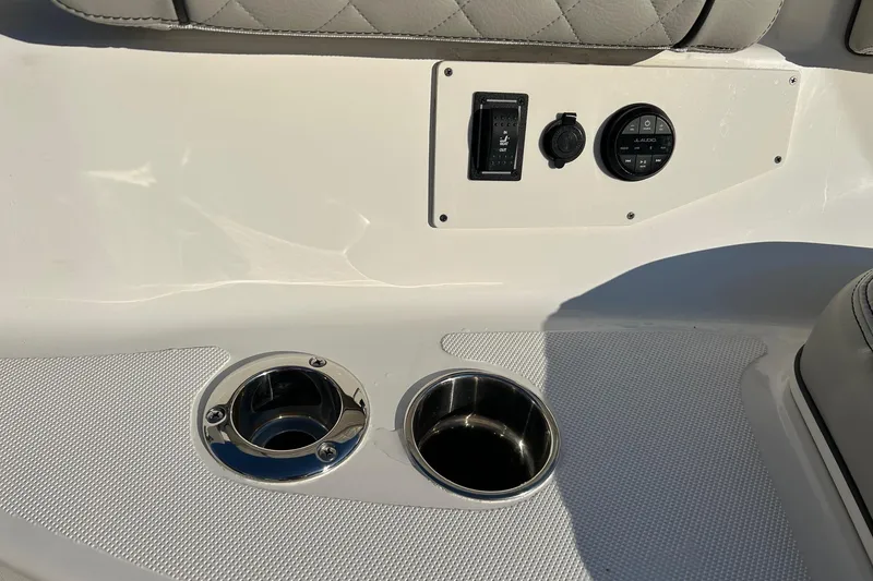 Slide: The Image of 2023 Pursuit S 378 Sport boat interior with cup holders and control panel. - 10