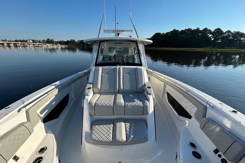 Slide: The Image of 2023 Pursuit S 378 Sport boat with luxurious seating on calm water. - 2