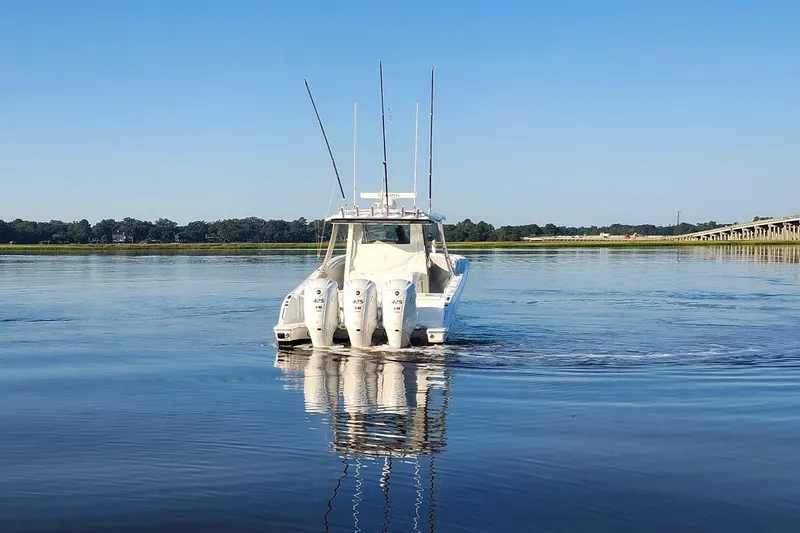 Slide: The Image of 2023 Pursuit S 378 Sport boat on calm water with clear blue sky. - 26