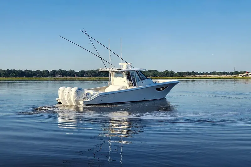Slide: The Image of 2023 Pursuit S 378 Sport boat cruising on calm water under clear blue sky. - 29
