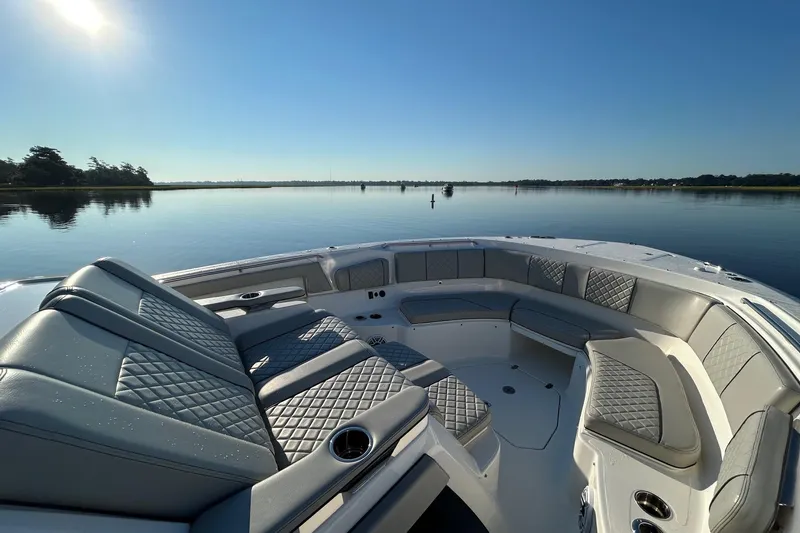 Slide: The Image of 2023 Pursuit S 378 Sport boat interior with luxurious seating on calm water. - 5