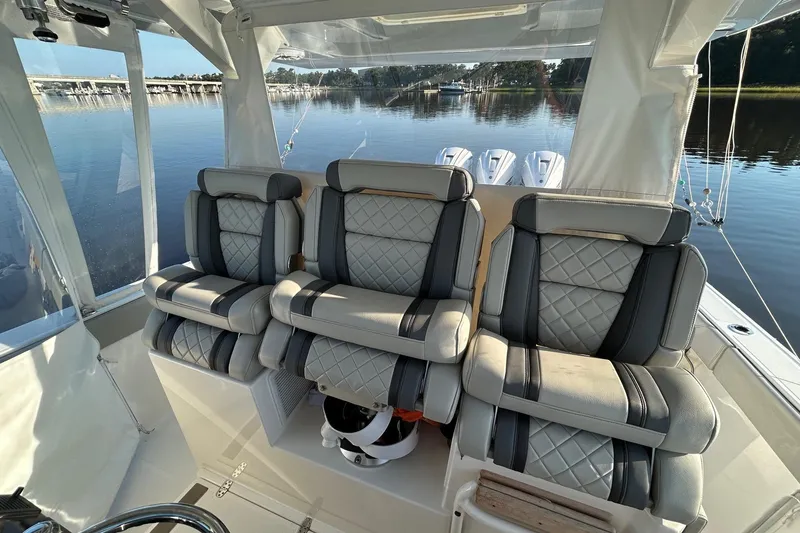 Slide: The Image of 2023 Pursuit S 378 Sport boat interior with luxurious seating and scenic water view. - 6